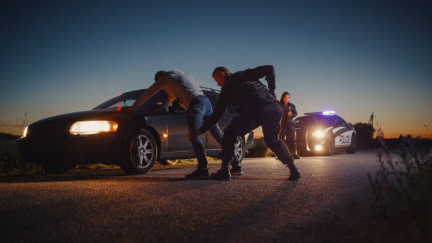 istock A Professional Middle Aged Policeman Performing a Pat-Down Search on a Fellon With his Hands on Car Hood. Documentary-like Shot of Procedure of Arresting Suspects. Experienced Cop Looking for Weapons 1480290013