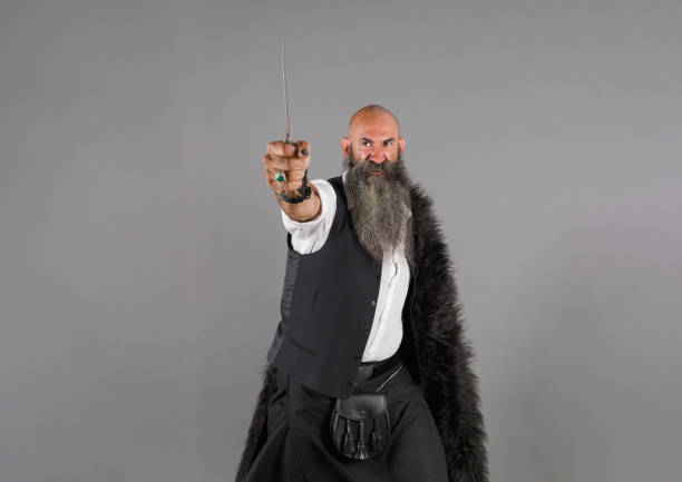 istock a bearded man performing a warrior holding a knife with a fierce expression in his face 1480291410