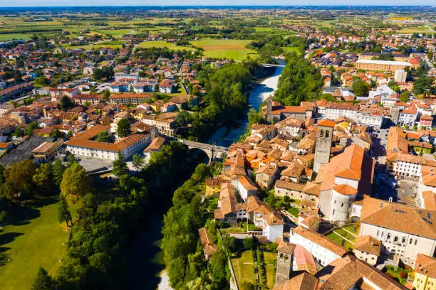 Scenic aerial view of historic centre of Cividale del Friuli on Natisone river with medieval stone Devil Bridge and Cathedral parish church, Italy