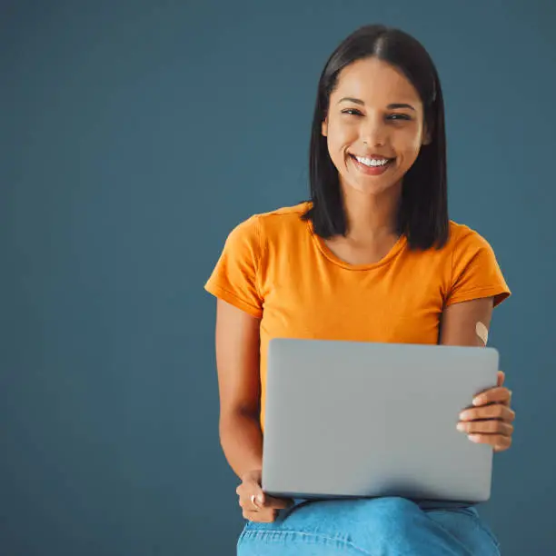 Photo of Laptop, woman and smile in portrait with mockup space, communication and technology isolated on studio background. Email, blog and copywriting with writer, happy person and connectivity with website