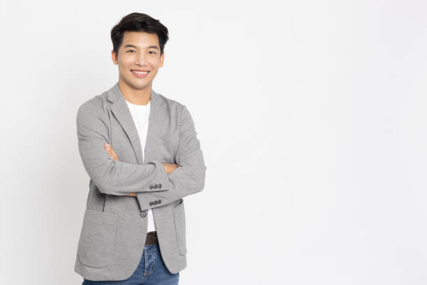 young asian businessman smiling with arms crossed isolated on white background - businessman business arms crossed business person imagens e fotografias de stock