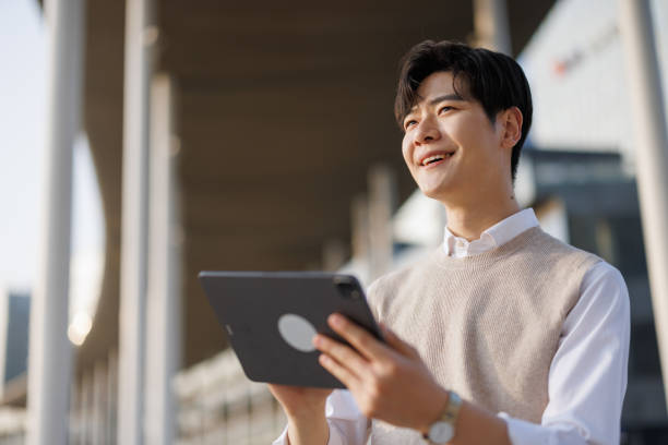 Asian freelancers using digital tablets outdoors
