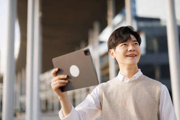 istock Young Asian freelancers using digital tablets outdoors 1480293466