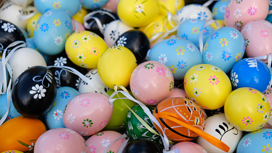 Easter. Flower basket full of colored eggs.