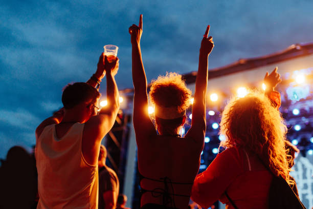 Three young friends at music concert