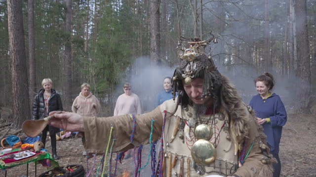 Male shaman performs a rite of gratitude to the family