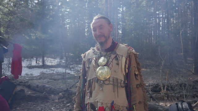 Male shaman is resting after a shaman dance.