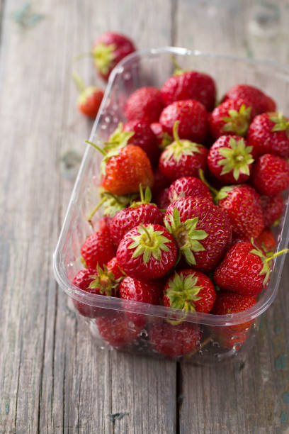 istock ripe red strawberry in a plastic container top view 1480300606