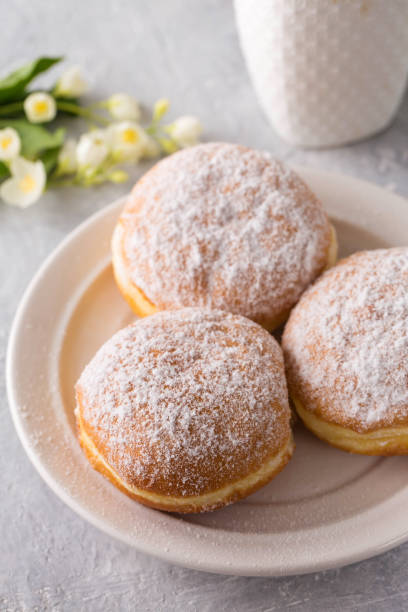 istock donuts berliners with filling sprinkled with powdered sugar on a white plate 1480300666