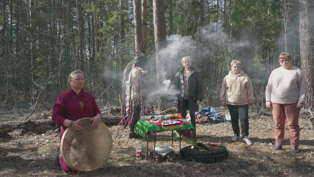 Male shaman performs a rite of gratitude to the family
