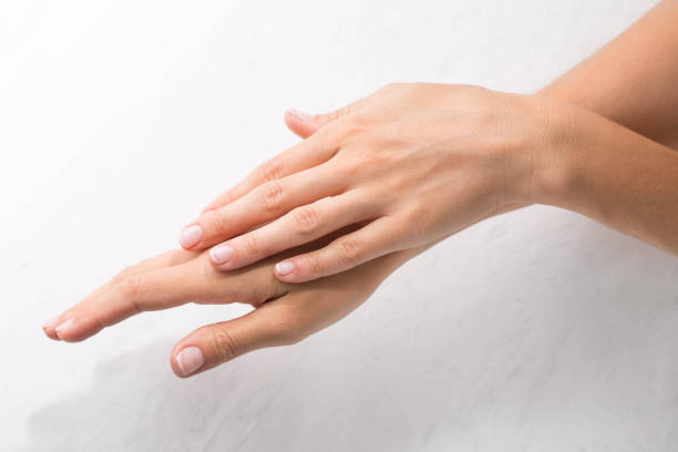 istock Female hands with minimalist manicure on white background 1480300723