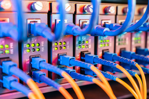 istock Fiber Optical cables connected to an optic ports and Network cables connected to ethernet ports 1480300893