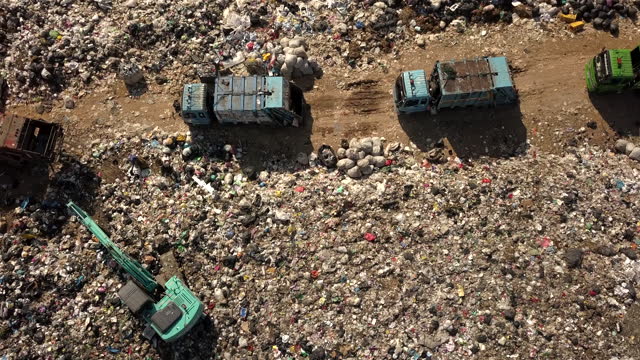 Aerial view landfill with garbage trucks