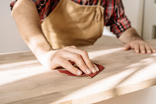 Carpenter works with wood in the workshop. Small business, production, craft concept. High quality photo