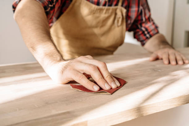 Carpenter works with wood in the workshop. Small business, production, craft concept. Carpenter works with wood in the workshop. Small business, production, craft concept. High quality photo sand paper stock pictures, royalty-free photos & images