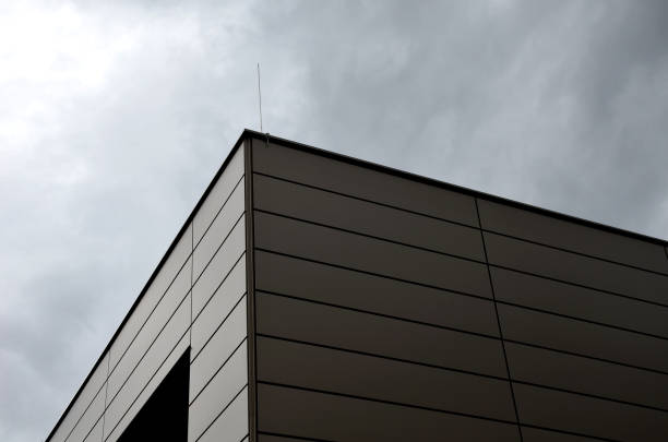 istock cladding of a building with a expanded metal lattice structure. galvanized gray nets protect the industrial building. Blue sky in contrast to a silver background, wall, corner, slanted, sheet metal 1480307114