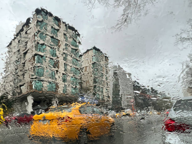 istock rain drops on window over city view and road 1480307172