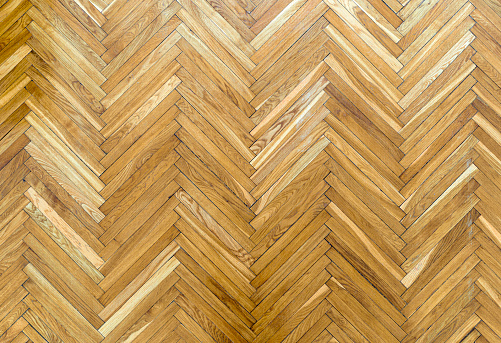 Wooden parquet floor background. Old vintage parquet on the floor in the living room. Interior design concept. High quality photo