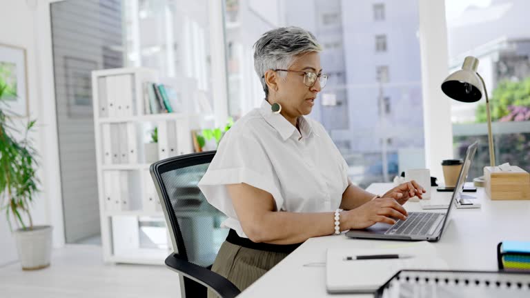 Business, woman and laptop typing in office for planning, research and review. Female manager, computer keyboard and technology for website management, email networking or online administration notes