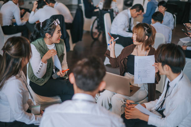 istock Asian workshop participants in small group discussion, brainstorming during business workshop class 1480315244