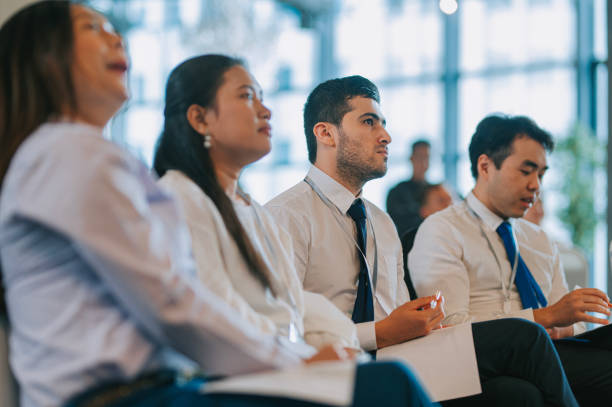 istock Asian Seminar Participants listening to presenter speech on stage 1480316646