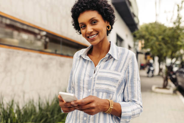 istock Happy young woman using a smartphone outdoors 1480316689