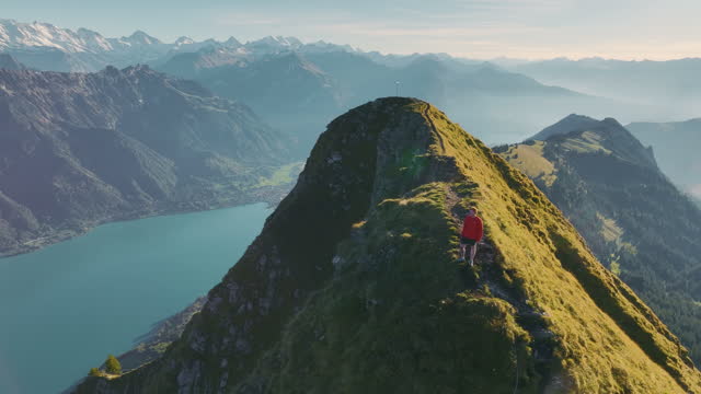 Aerial view of man hiking  on the background of Interlaken in Swiss Alps