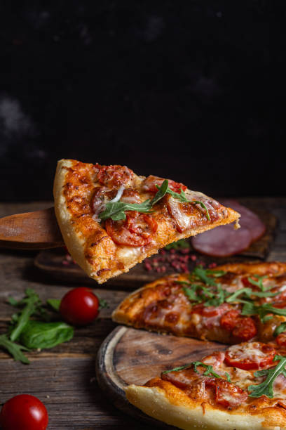 istock Appetizing pizza with ham on a wooden background 1480319258