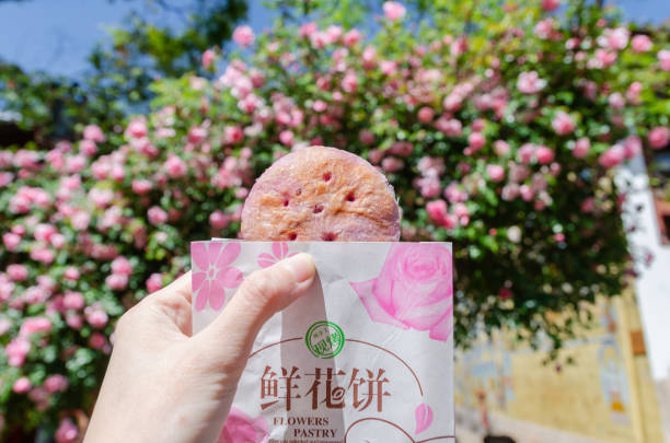 Flower pastry is a traditional snack from the city of Yunnan, China. The main ingredient for Flower Cake are roses stock photo