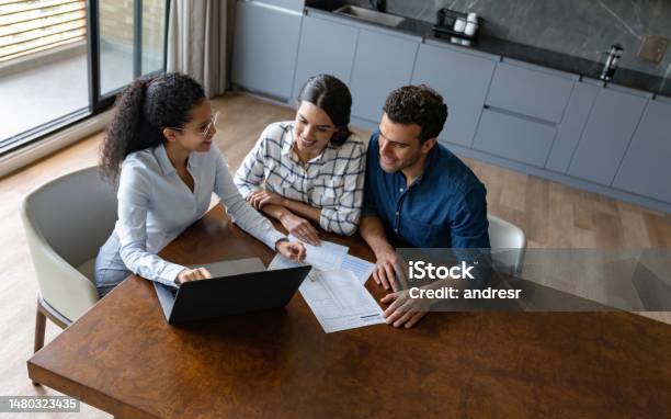 Financial Advisor Talking To A Couple About Their Home Finances Stock Photo - Download Image Now