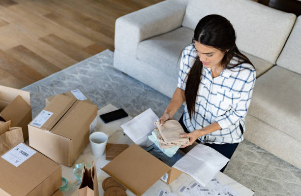 istock E-commerce clothing store owner packing orders at home 1480323522