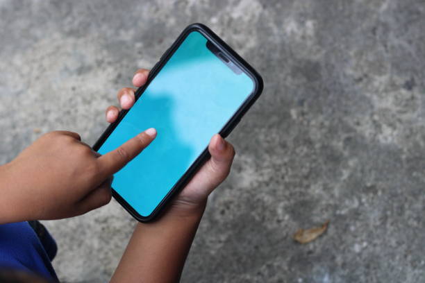 istock Photo of a blank screen cellphone in hand 1480326737
