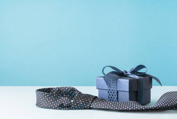 istock Happy Fathers Day background. gift box and necktie on blue table. 1480327328