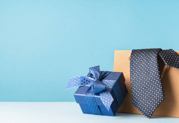 istock Happy Fathers Day background. gift box and necktie on blue table. 1480327332