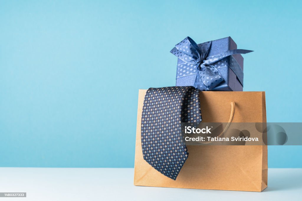 happy father's day or business gift Happy Father's Day. dark blue tie in paper bag with gift box. Father's Day sale mockup. Gift delivery service. Copy space Gift Stock Photo