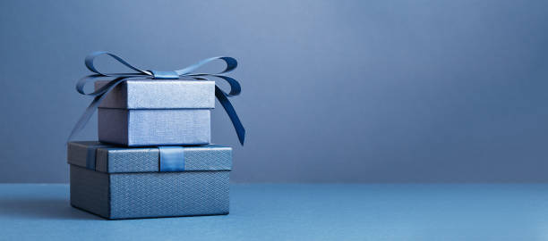 istock Two gift boxes with a blue bow on blue monochrome 1480327339