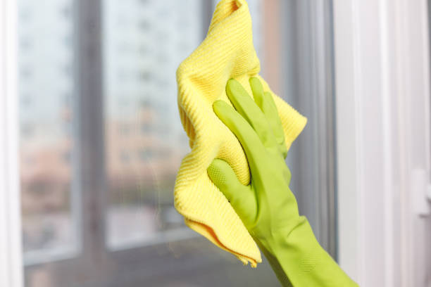 istock Hand in Green Glove Wiping Window with Microfiber Rag. Professional Cleaning Service 1480329353