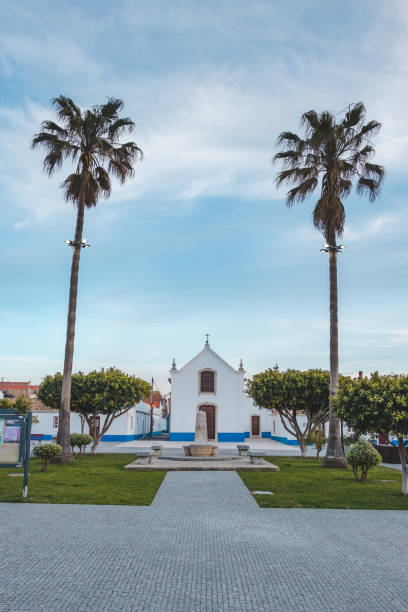 Beauty of the architecture and the church in Porto Covo in the typical white and blue colours of the local square. A village in western Portugal stock photo