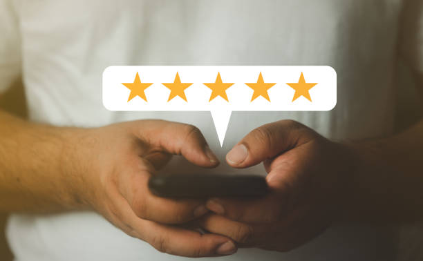 istock Man hand using smartphone with popup five star icon for feedback review satisfaction service. 1480332372