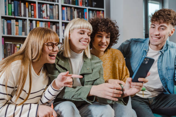 istock Group of young people using smart phone in the library 1480334154
