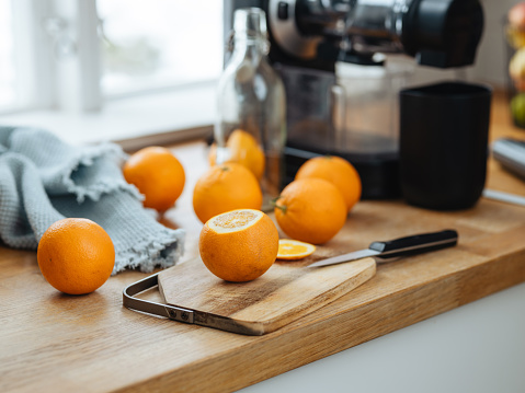 Freshly pressed orange juice and electric slow juicer
Photo taken indoors in kitchen