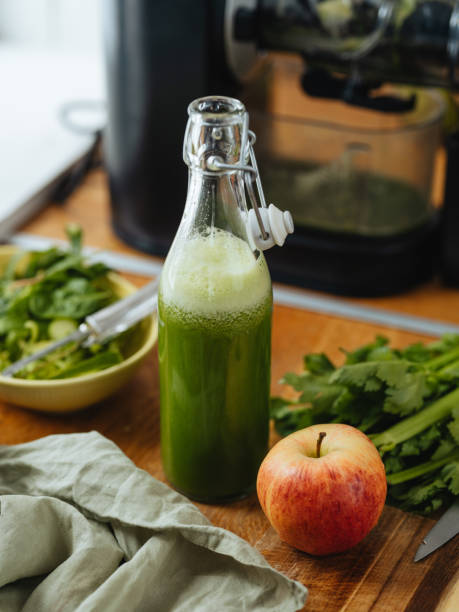 istock Green freshly pressed juice and electric slow juicer 1480334484