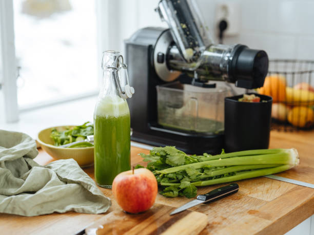 istock Green freshly pressed juice and electric slow juicer 1480335045