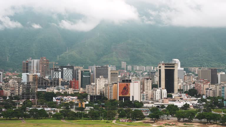 Aerial static view of Caracas downtown. High buildings with the mountains on the background. The most dangerous cities in the world