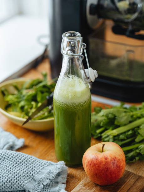 istock Green freshly pressed juice and electric slow juicer 1480336928