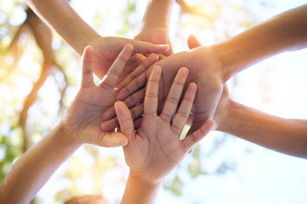 istock Hands, community and group in unity for trust, support or teamwork goals piling together below for collaboration in nature. Hand of people in solidarity, union or coordination for united team effort 1480338062