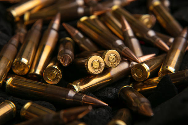 istock Cartridges for automatic carbine caliber .223 on charcoal. Ammunition for automatic and semi-automatic rifles. Dark background. 1480341219