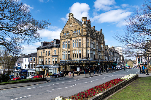 Harrogate, UK - April 3, 2023.  The exterior Victorian architecture of Betty's Cafe and Tea Rooms in Harrogate, North Yorkshire with Springtime floral display in this popular tourist destination