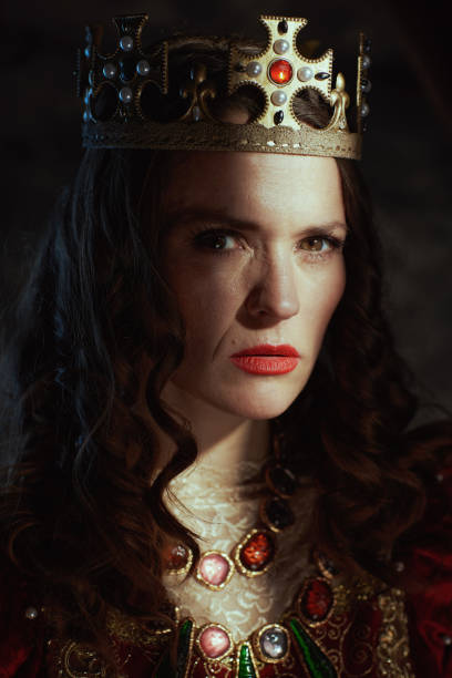 istock medieval queen in red dress with crown 1480343039