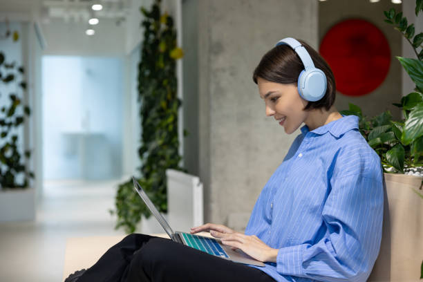 istock Joyful female working on her laptop in a coworking space 1480344937